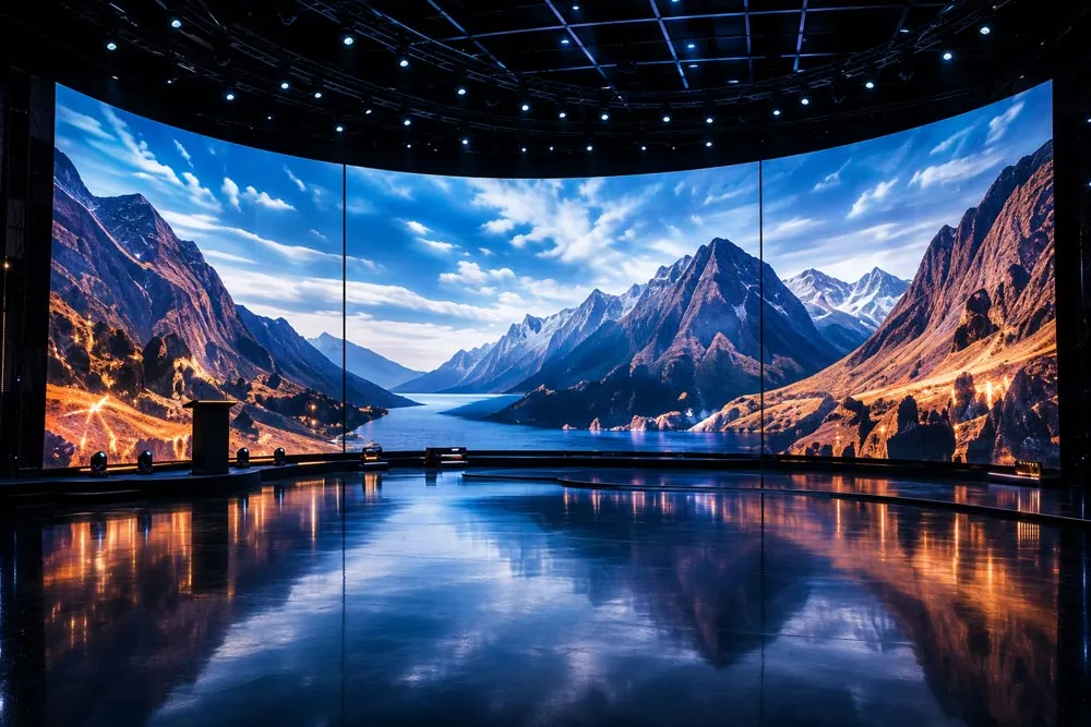A large curved LED wall showing a landscape scene